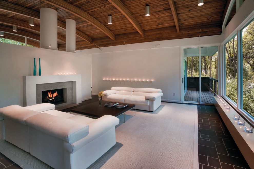 This is an example of a large contemporary living room in Other with white walls, slate flooring, a standard fireplace and a stone fireplace surround.