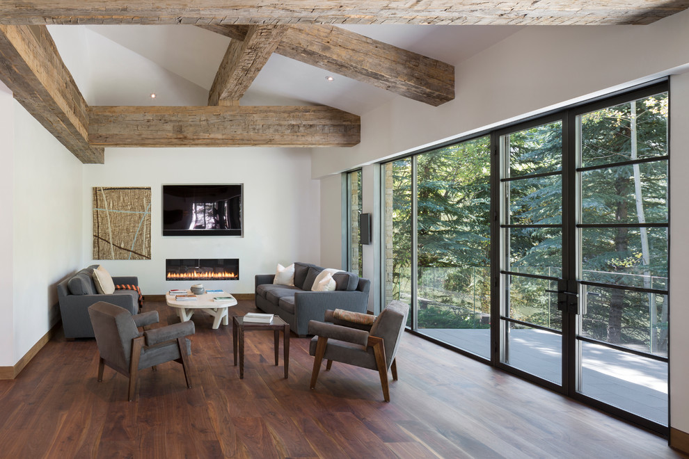 This is an example of a medium sized contemporary formal open plan living room in Denver with white walls, medium hardwood flooring, a ribbon fireplace, a plastered fireplace surround and a wall mounted tv.