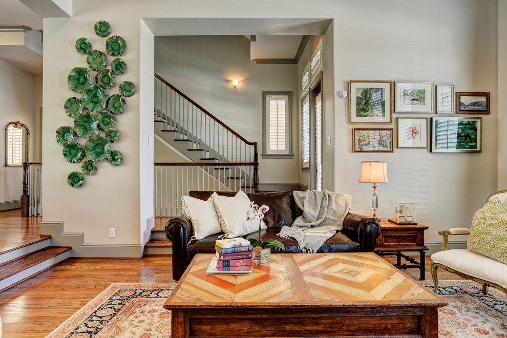 Classic open plan living room in Houston with beige walls, medium hardwood flooring and no tv.