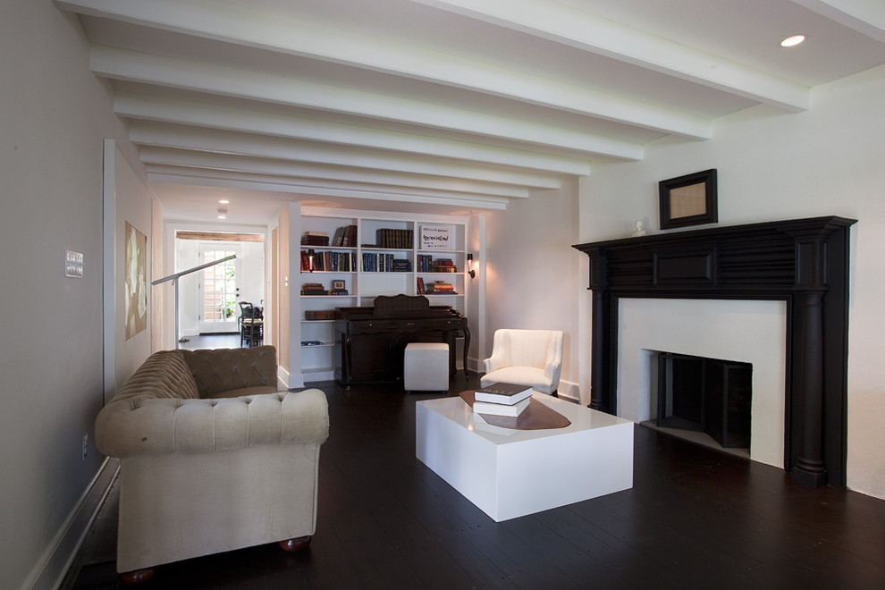 Inspiration for a cottage dark wood floor living room remodel in Philadelphia with white walls, a standard fireplace and a wood fireplace surround