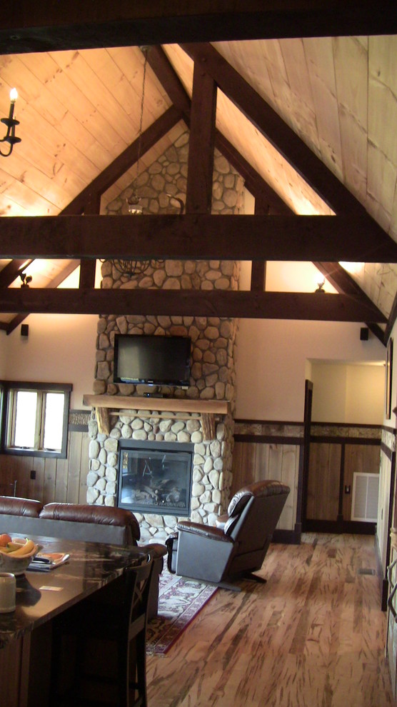 Example of a large arts and crafts open concept and formal dark wood floor living room design in Charlotte with a wall-mounted tv, yellow walls, a standard fireplace and a stone fireplace