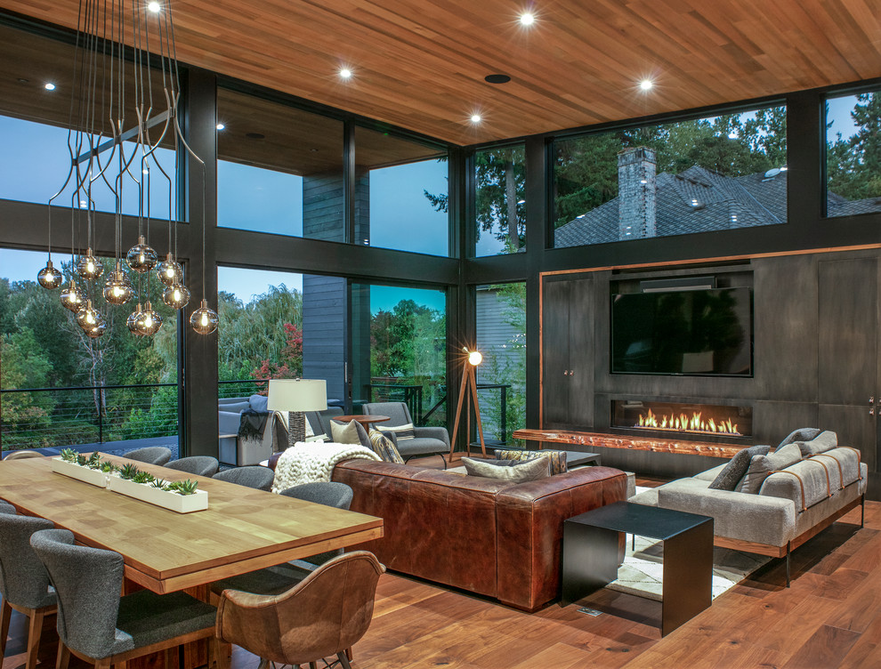 Photo of a contemporary living room in Portland with dark hardwood flooring, a ribbon fireplace and brown floors.