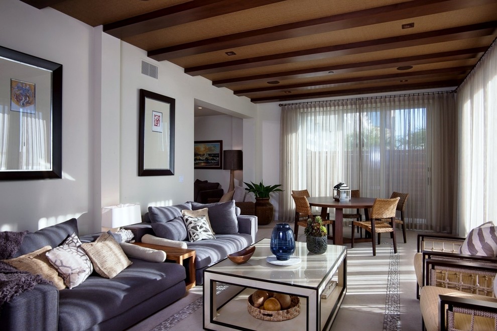 Photo of a large contemporary formal open plan living room in San Diego with white walls, limestone flooring, no tv and beige floors.