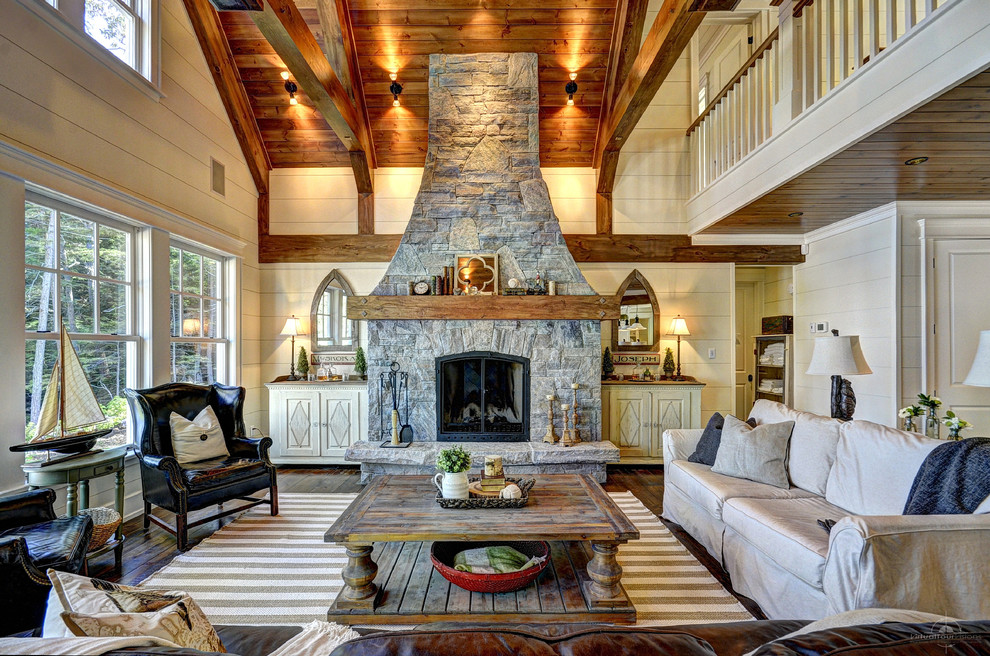 This is an example of a rustic formal living room in Toronto with beige walls, dark hardwood flooring, a standard fireplace, a stone fireplace surround and no tv.