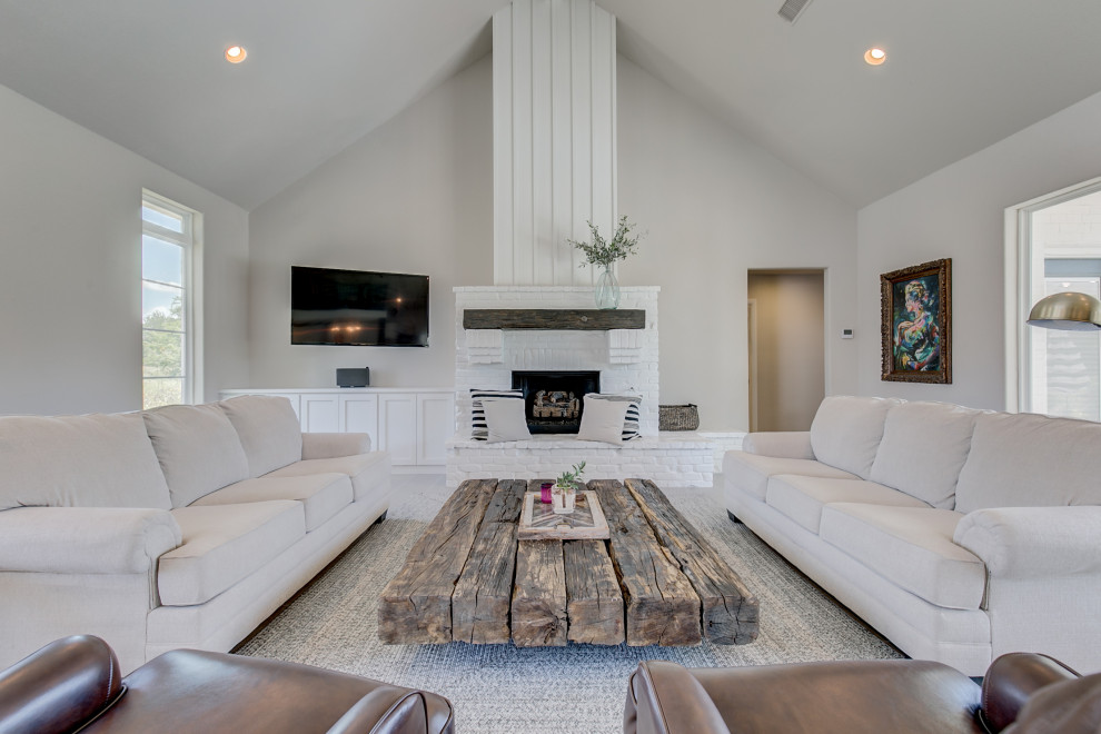 Medium sized rustic open plan living room in Dallas with grey walls, ceramic flooring, a standard fireplace, a brick fireplace surround and grey floors.