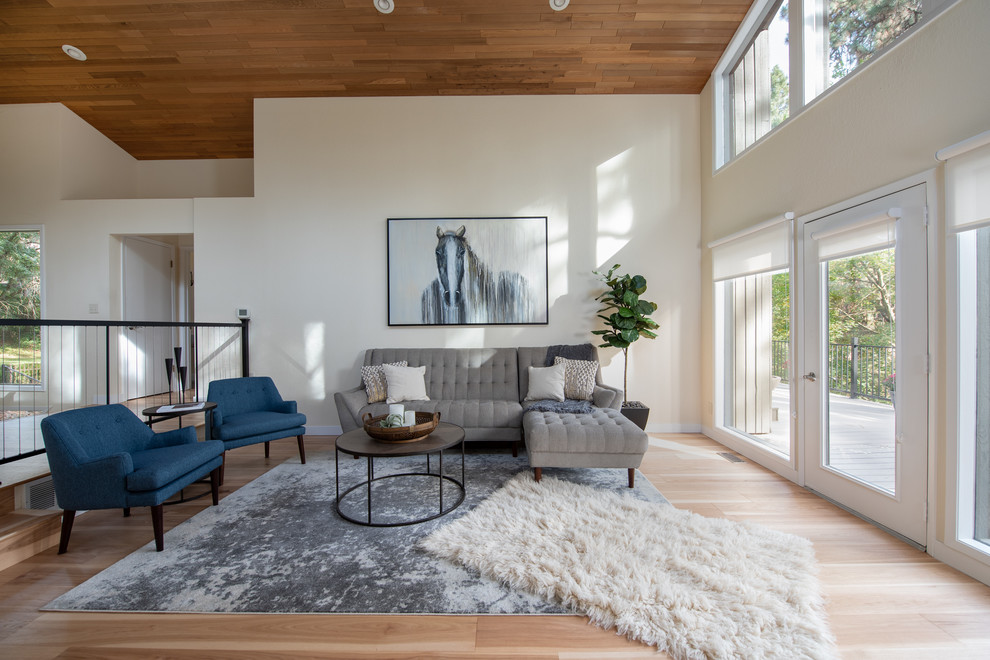 Esempio di un grande soggiorno contemporaneo con pareti bianche, pavimento marrone e pavimento in legno massello medio