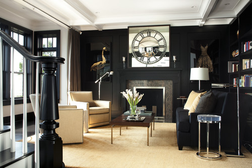 living room with black walls and artwork on either side of the fireplace