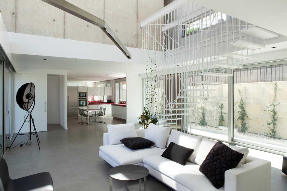 This is an example of a large contemporary formal open plan living room in Madrid with white walls, ceramic flooring, no fireplace and no tv.