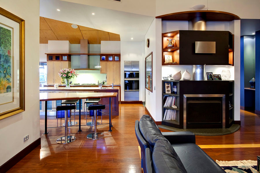 Example of a huge transitional open concept medium tone wood floor and brown floor living room design in Brisbane with multicolored walls, a standard fireplace and a wall-mounted tv