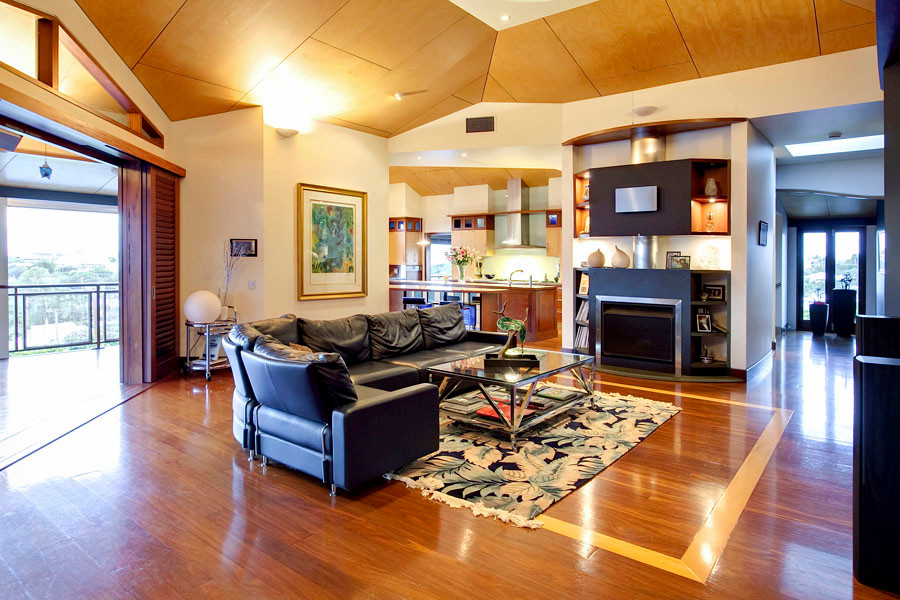 Foto di un ampio soggiorno classico aperto con pareti multicolore, pavimento in legno massello medio, camino classico, TV a parete e pavimento marrone