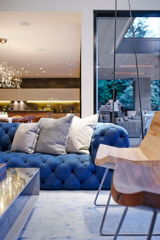 Example of a mid-sized trendy open concept light wood floor living room design in Vancouver with white walls, a standard fireplace, a concrete fireplace and a media wall