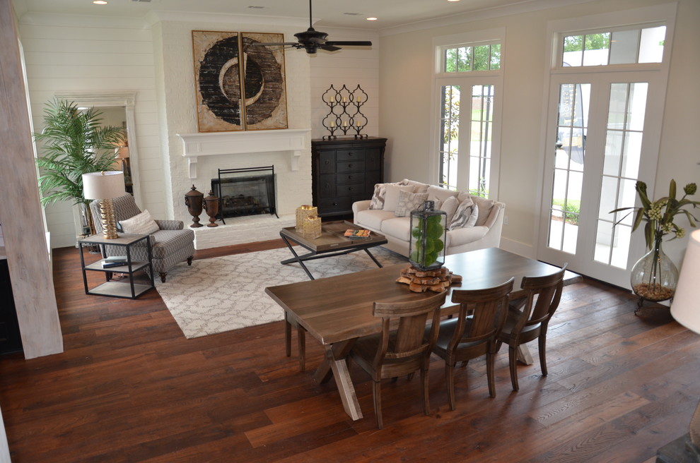 Example of a mid-sized transitional formal and open concept medium tone wood floor living room design in New Orleans with white walls, a standard fireplace, a brick fireplace and no tv