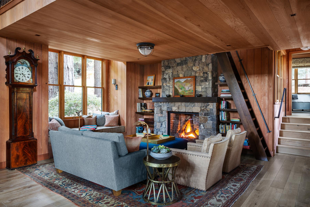 Living room - mid-sized rustic formal and open concept medium tone wood floor and gray floor living room idea in San Francisco with a standard fireplace, a stone fireplace, no tv and brown walls