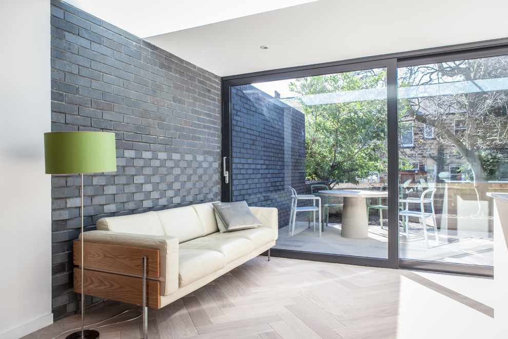 Modernes Wohnzimmer ohne Kamin mit weißer Wandfarbe, hellem Holzboden und braunem Boden in Sonstige