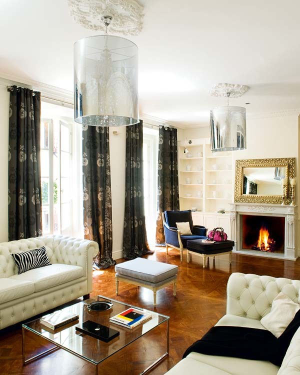 Example of a large classic formal and open concept medium tone wood floor living room design in Madrid with white walls, a standard fireplace, a stone fireplace and a media wall