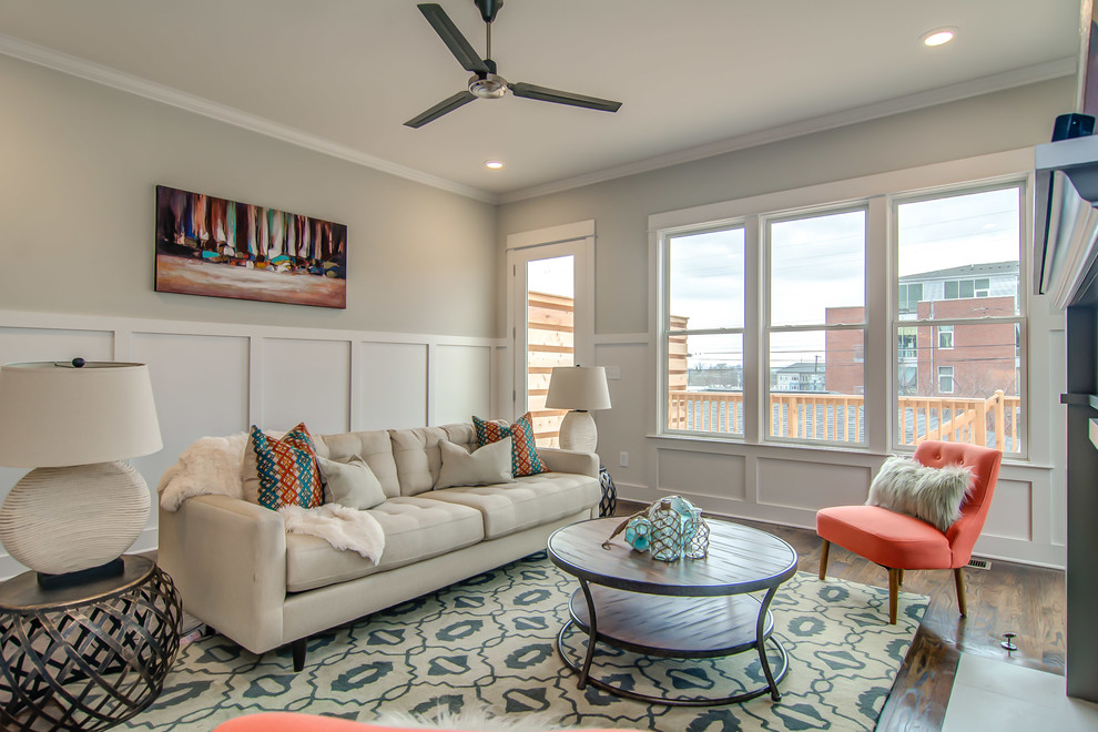 Traditional living room in Nashville with grey walls and medium hardwood flooring.