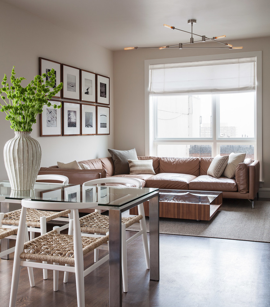 Contemporary open plan living room in San Francisco with beige walls and dark hardwood flooring.