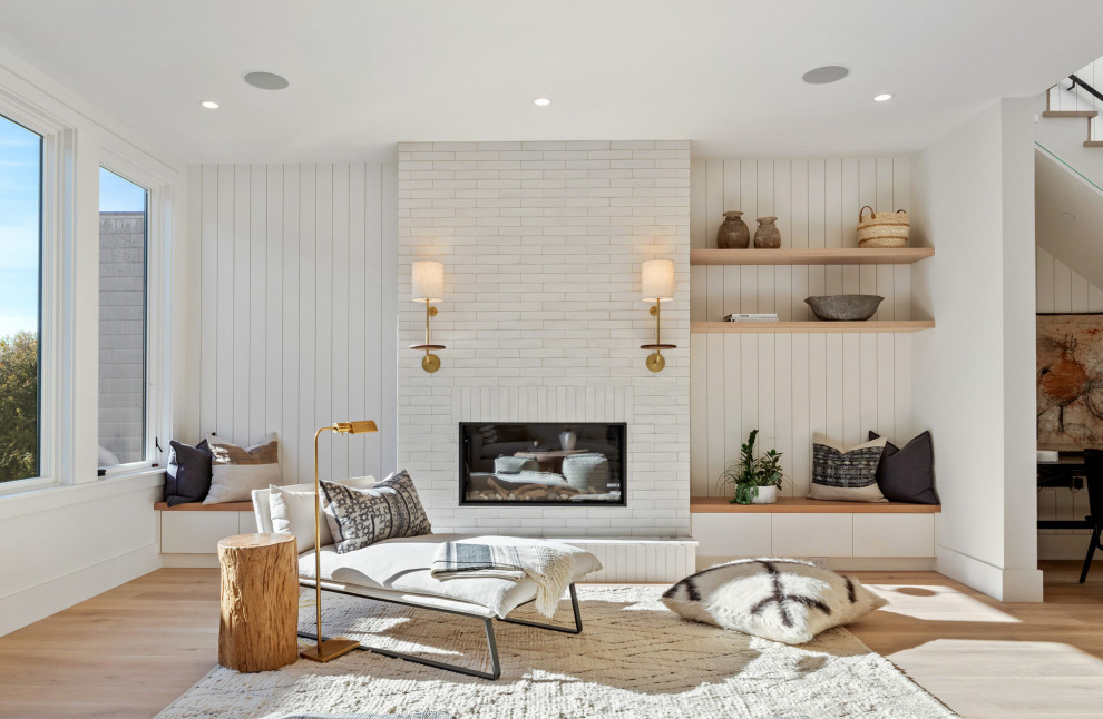 Inspiration for a contemporary formal living room in San Francisco with white walls, medium hardwood flooring, a standard fireplace, a brick fireplace surround, no tv, brown floors and panelled walls.