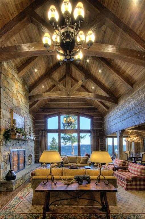 Inspiration for a large rustic formal and open concept dark wood floor living room remodel in Other with brown walls, a standard fireplace and a stone fireplace