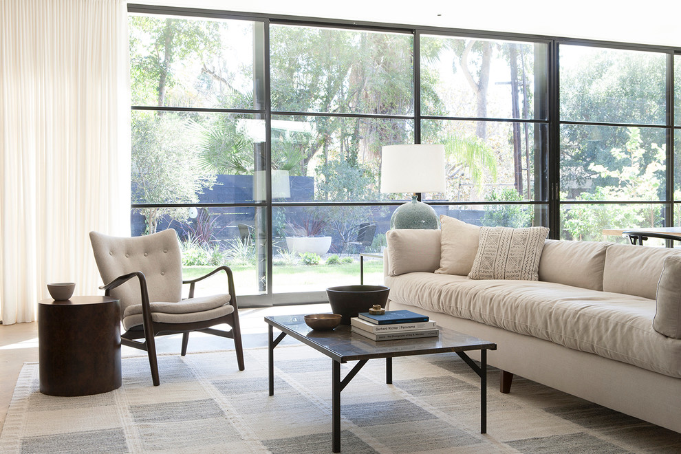 Immagine di un soggiorno minimalista di medie dimensioni e stile loft con pareti beige, pavimento in cemento e nessuna TV
