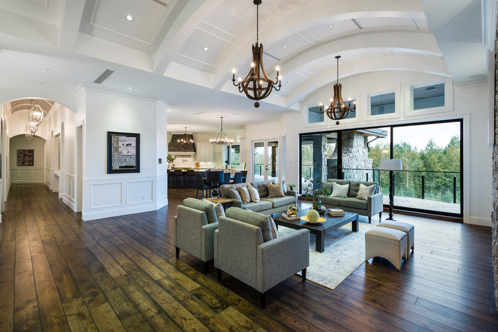 Inspiration for a huge rustic formal and open concept medium tone wood floor and brown floor living room remodel in Vancouver with white walls, a standard fireplace, a stone fireplace and no tv