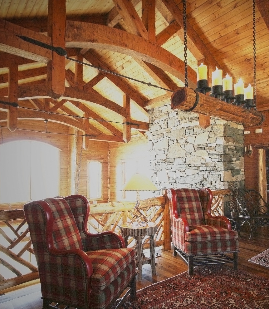 Esempio di un grande soggiorno stile rurale stile loft con pareti marroni, pavimento in legno massello medio, camino classico, cornice del camino in pietra, sala formale e nessuna TV