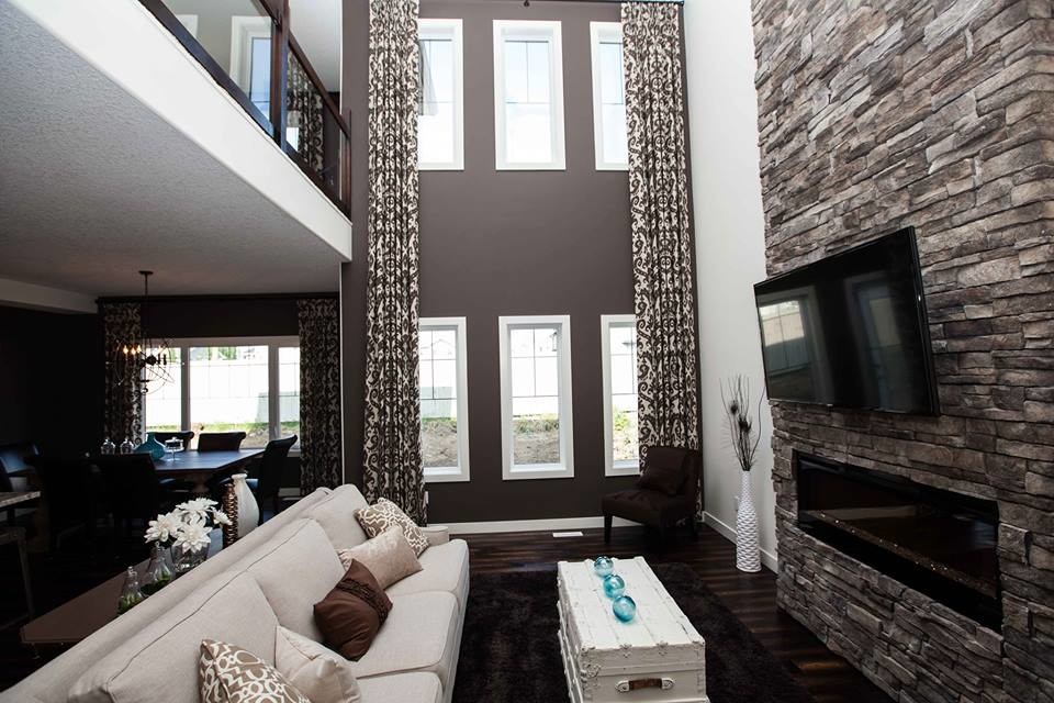 Example of a mid-sized mountain style formal and open concept dark wood floor living room design in Edmonton with brown walls, a standard fireplace, a brick fireplace and a wall-mounted tv