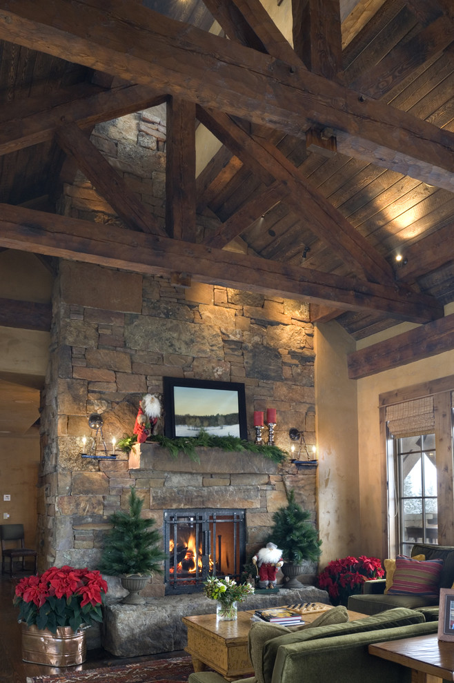 Inspiration for a rustic living room in Other with beige walls, a standard fireplace and a stone fireplace surround.