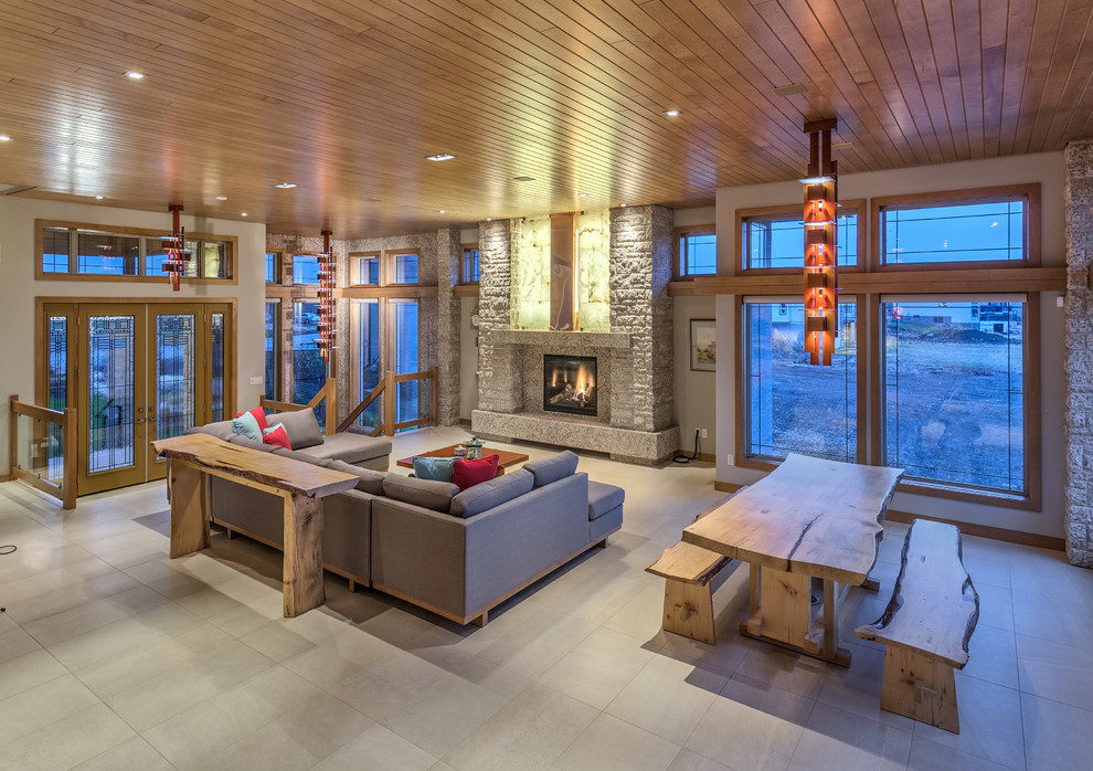 На фото: гостиная комната в стиле рустика с полом из керамической плитки, горизонтальным камином и фасадом камина из камня с
