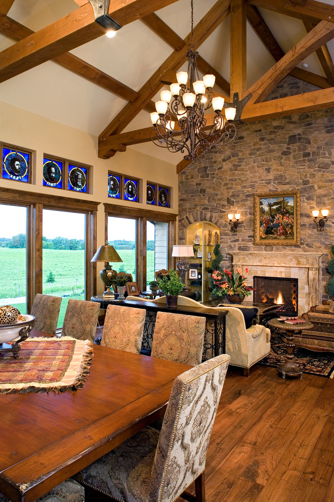 Photo of a rustic living room in Minneapolis with a stone fireplace surround.