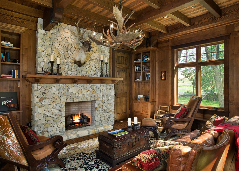 Idée de décoration pour un salon chalet avec une cheminée standard et un manteau de cheminée en pierre.