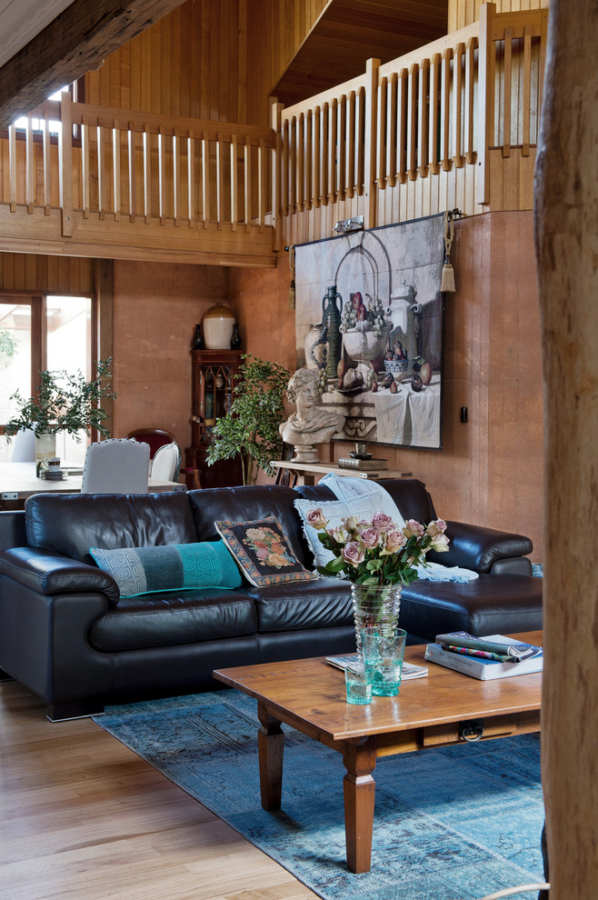 Inspiration for a rustic open plan living room in Perth with brown walls and light hardwood flooring.