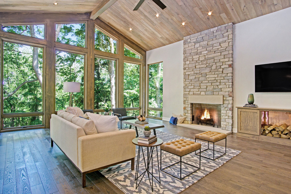 Idées déco pour un grand salon montagne ouvert avec un sol en bois brun, une cheminée standard et un manteau de cheminée en pierre.