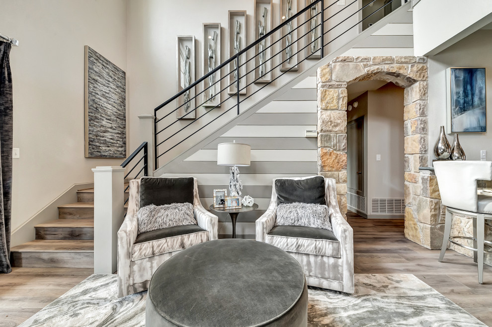 Design ideas for a large contemporary mezzanine living room in Dallas with grey walls, medium hardwood flooring, a standard fireplace, a stone fireplace surround, a built-in media unit and brown floors.