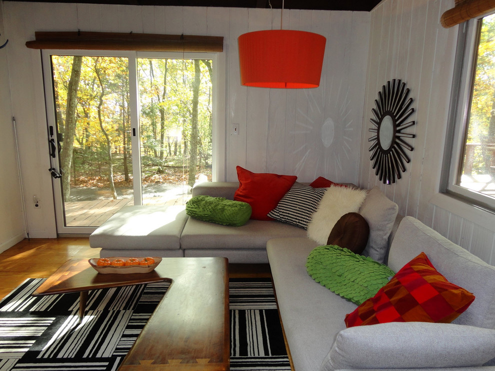 Inspiration for an eclectic medium tone wood floor living room remodel in New York