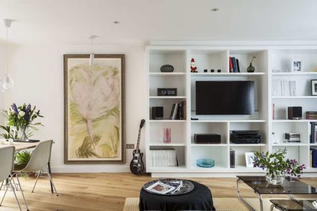 Medium sized contemporary open plan living room in London with a brick fireplace surround.
