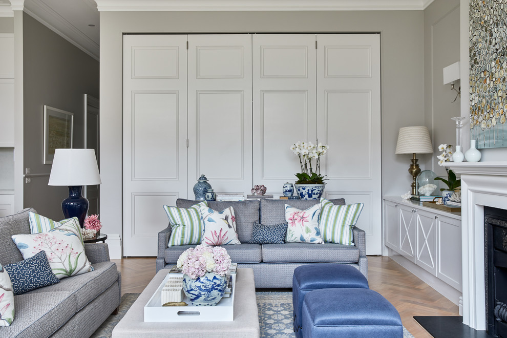 Classic living room in Melbourne with grey walls, light hardwood flooring, a standard fireplace, a wooden fireplace surround and a built-in media unit.