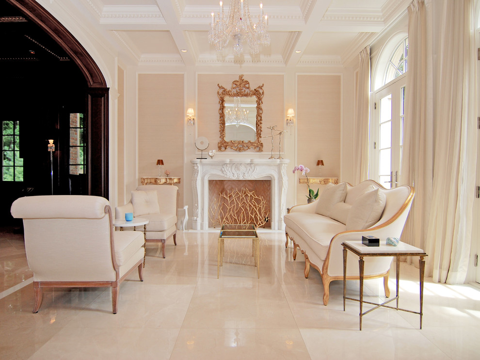 Cette photo montre un grand salon chic ouvert avec une salle de réception, un mur beige, un sol en marbre, une cheminée standard, un manteau de cheminée en pierre, aucun téléviseur et un sol beige.