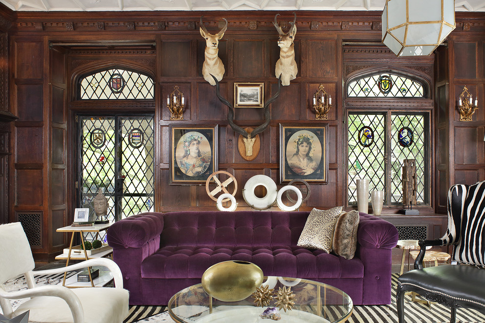 This is an example of a bohemian living room in New York with brown walls.