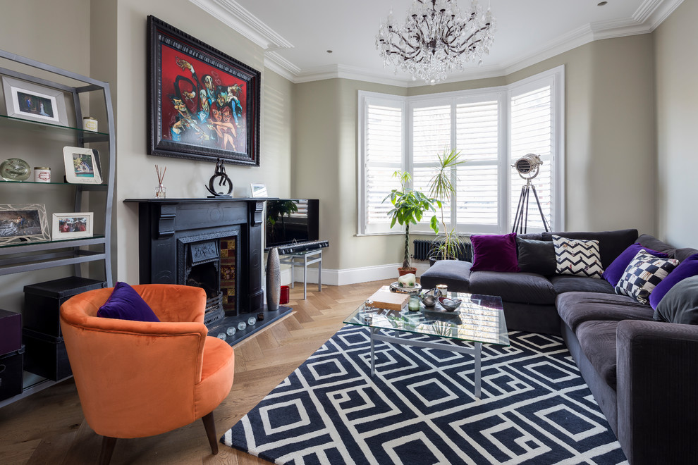 Classic formal enclosed living room in London with beige walls, light hardwood flooring and beige floors.