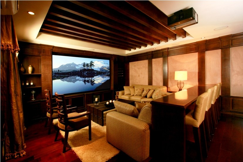 Ejemplo de cine en casa cerrado contemporáneo de tamaño medio con paredes beige, suelo de madera oscura y pared multimedia