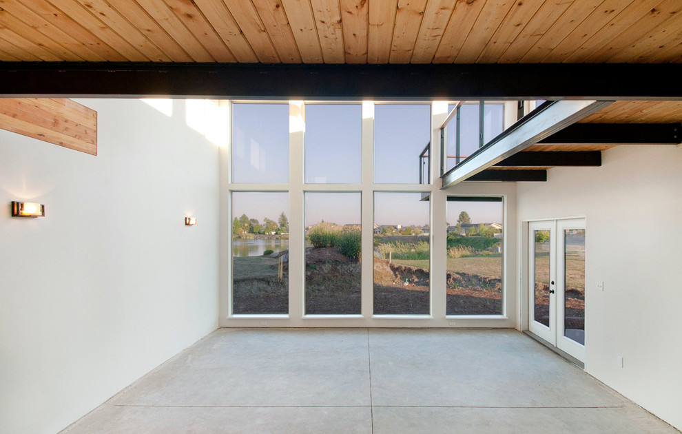 Foto di un soggiorno design di medie dimensioni e stile loft con pavimento in cemento