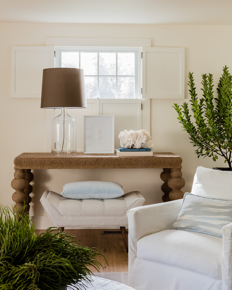 Example of a transitional open concept light wood floor living room design in Boston with white walls, a standard fireplace, a stone fireplace and a concealed tv