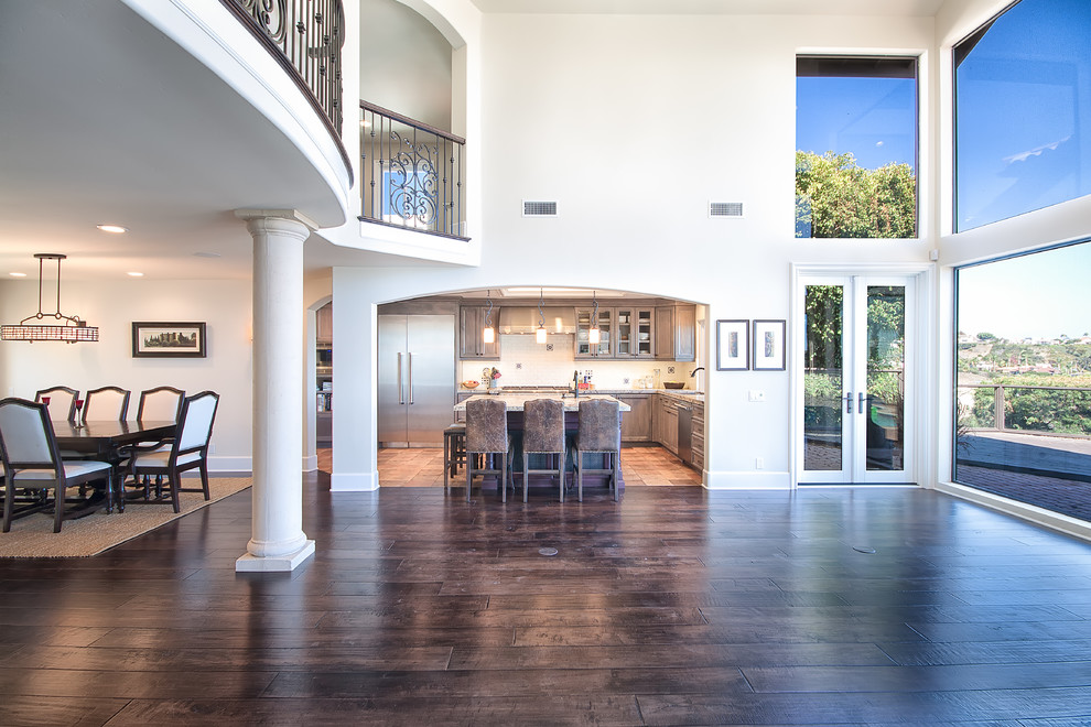 Inspiration for a large contemporary formal open plan living room in Orange County with white walls, dark hardwood flooring, no fireplace, no tv and brown floors.