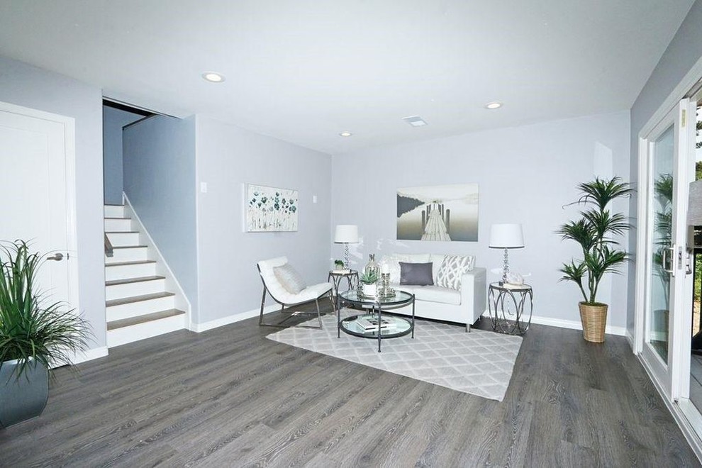 Photo of a medium sized contemporary open plan living room in San Diego with grey walls, grey floors and porcelain flooring.