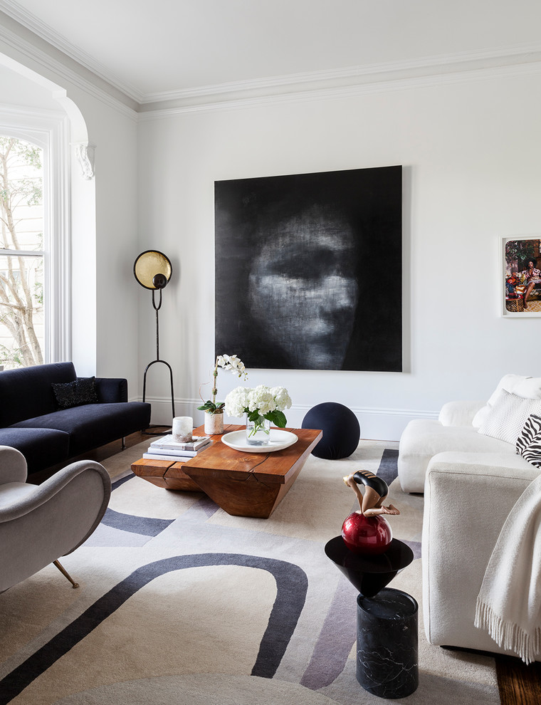 Photo of a contemporary enclosed living room in San Francisco with white walls and dark hardwood flooring.