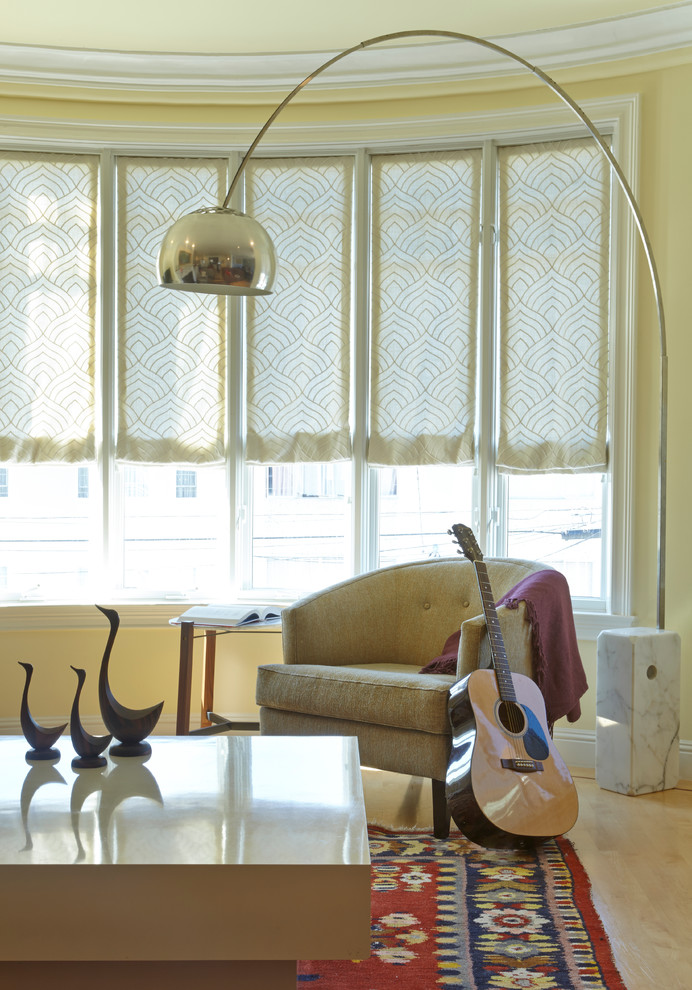 Ispirazione per un soggiorno minimalista di medie dimensioni con pareti gialle e parquet chiaro