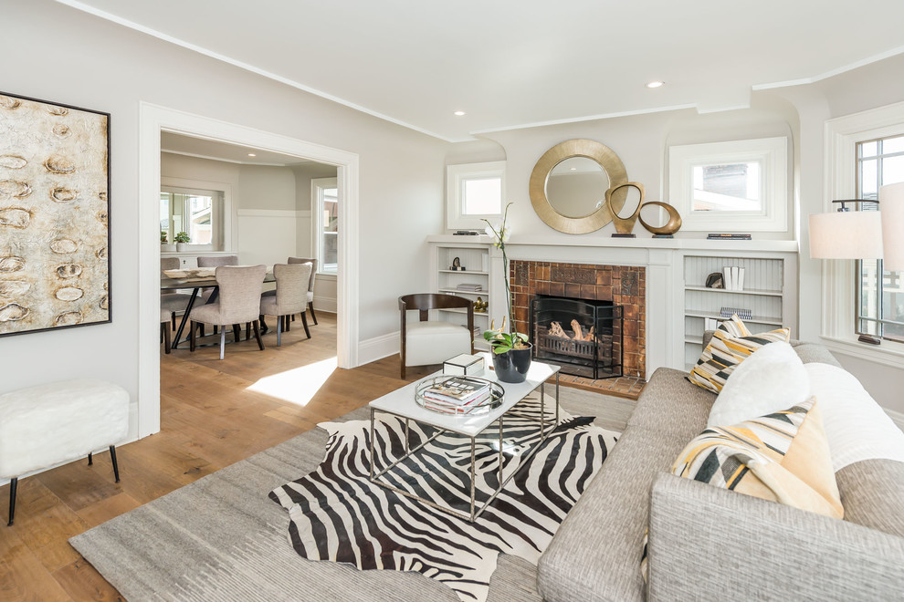 Photo of a medium sized traditional formal living room in San Francisco with grey walls, a standard fireplace and a tiled fireplace surround.