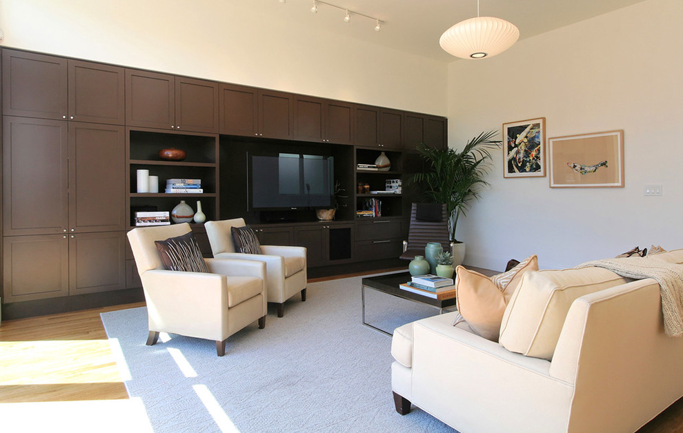 Trendy living room photo in San Francisco with white walls and a media wall