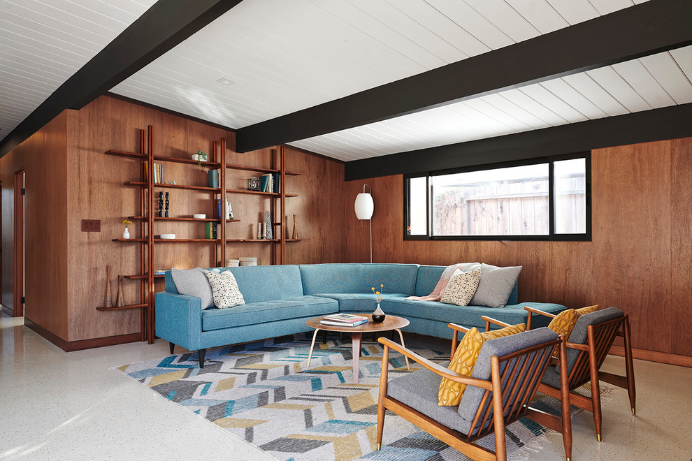 This is an example of a retro open plan living room in San Francisco with brown walls, vinyl flooring, white floors, a reading nook, no fireplace and no tv.